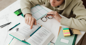 a person sitting at a table with an open book