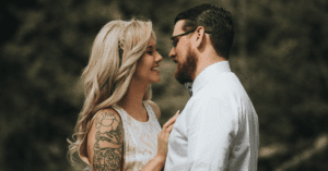 bride and groom embracing in front of trees