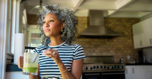 woman holding a green smoothie