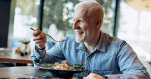 A man eating a bowl of food in a restaurant