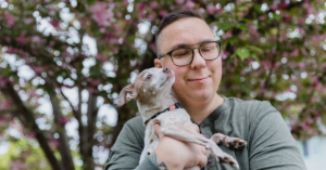 portrait of a person holding a dog