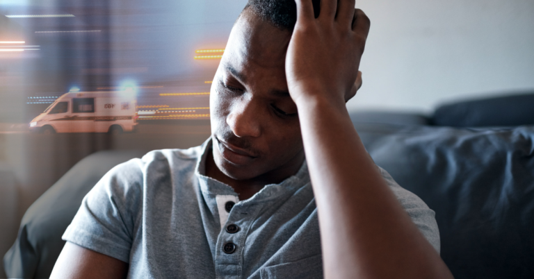 man sitting with hand held to his temple, indicating that he has a headache. in the background an overlay of an ambulance speeding through is seen, plying the man is reminded of a recent car accident.