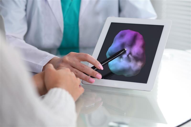 Physician reviewing a SPECT scan on a tablet