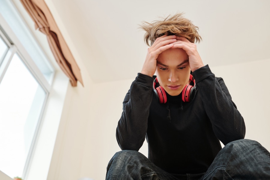 Young man struggling with mental health symptoms
