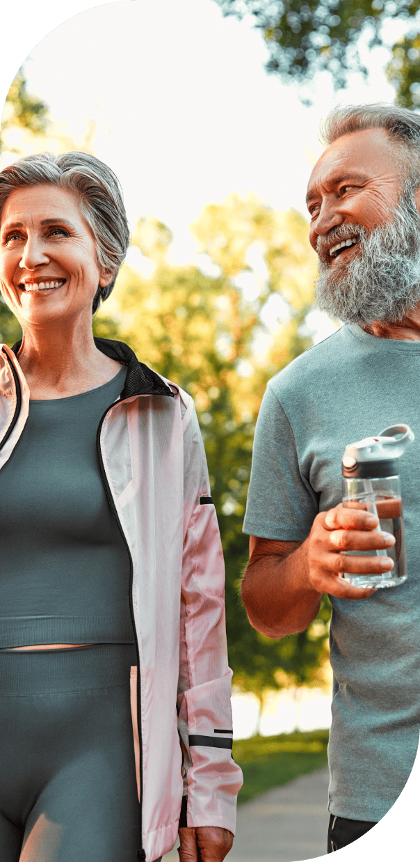 Older couple smiling and walking together outdoors