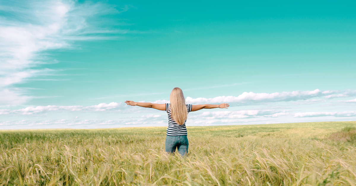 woman walking through a field